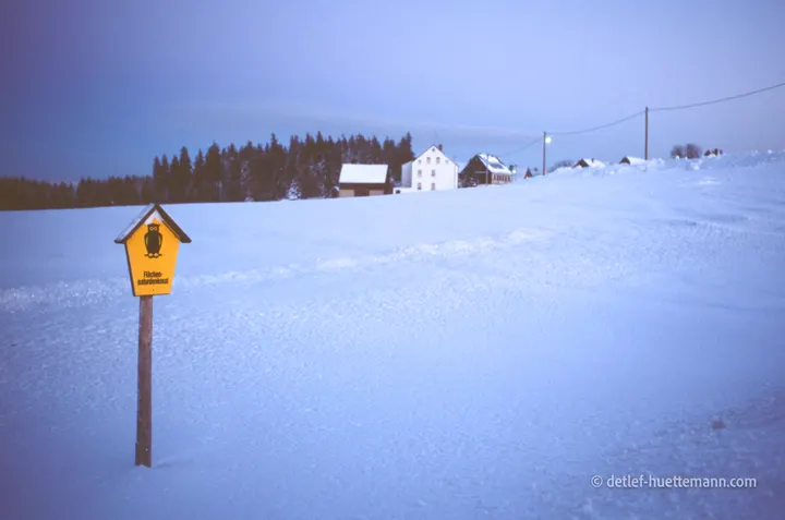 Schild „Flächennaturdenkmal" in der blauen Stunde